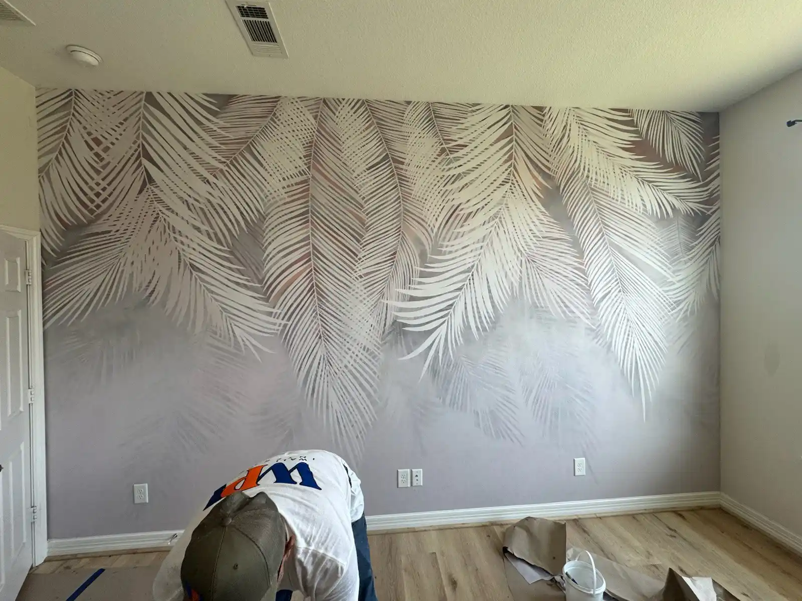 Professional wallpaper installer at work in New York